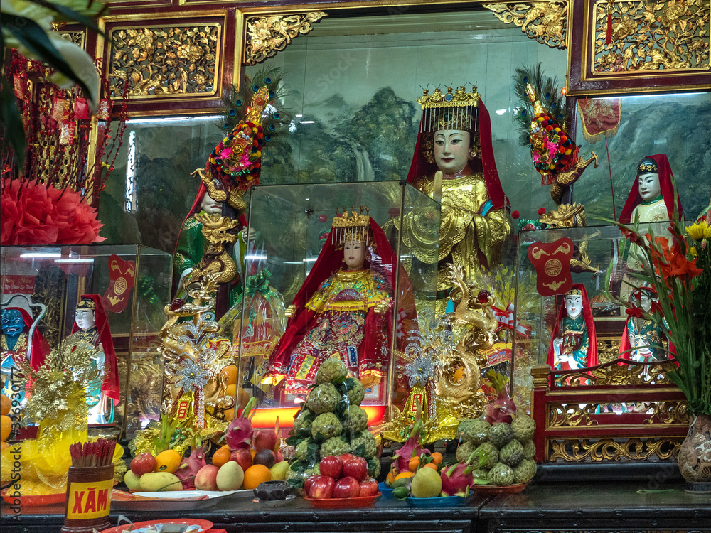 Chinese gods on altar with sacrifices in vietnam