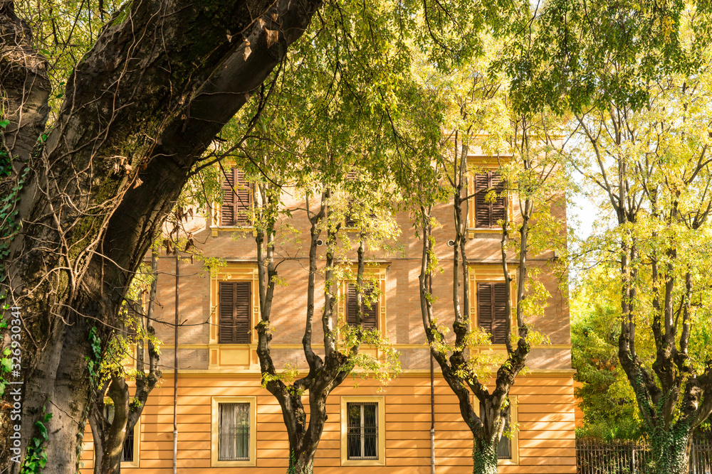 Φωτογραφία Orange apartment with shutters in street with trees, called Via S Giovanni del Cantone
