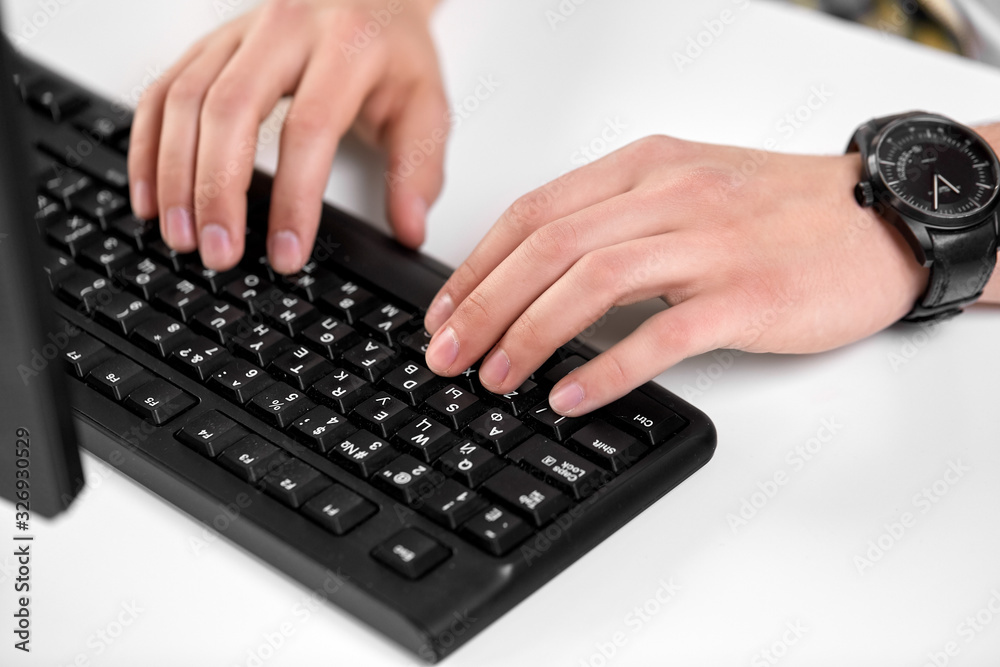 technology and people concept - male hands with red manicure typing on computer keyboard on table technology and people concept - male hands with red manicure typing on computer keyboard on table