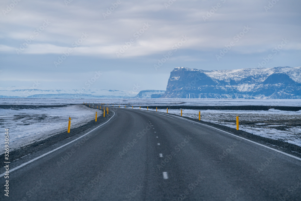 Rural curve highway road among the snow mountain in Iceland Rural curve highway road among the snow mountain in Iceland