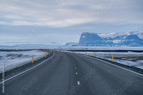 Rural curve highway road among the snow mountain in Iceland