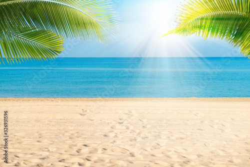 Fototapeta Naklejka Na Ścianę i Meble -  Tropical sea beach with sand, ocean, palm leaves and blue sky