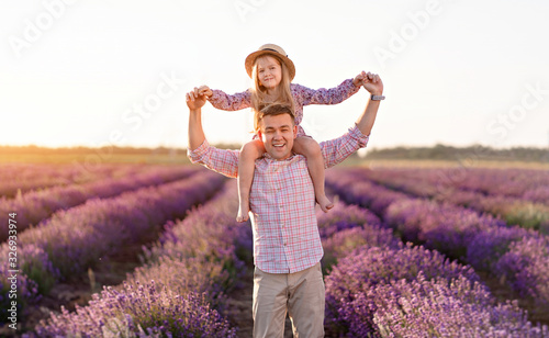 Fototapeta Naklejka Na Ścianę i Meble -  father with daughter in lavender field at sunset.