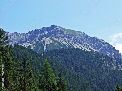 Alpine mountain peak Stachlerkopf over the Saminatal alpine valley and in the Liechtenstein Alps mountain massiv - Steg, Liechtenstein photo