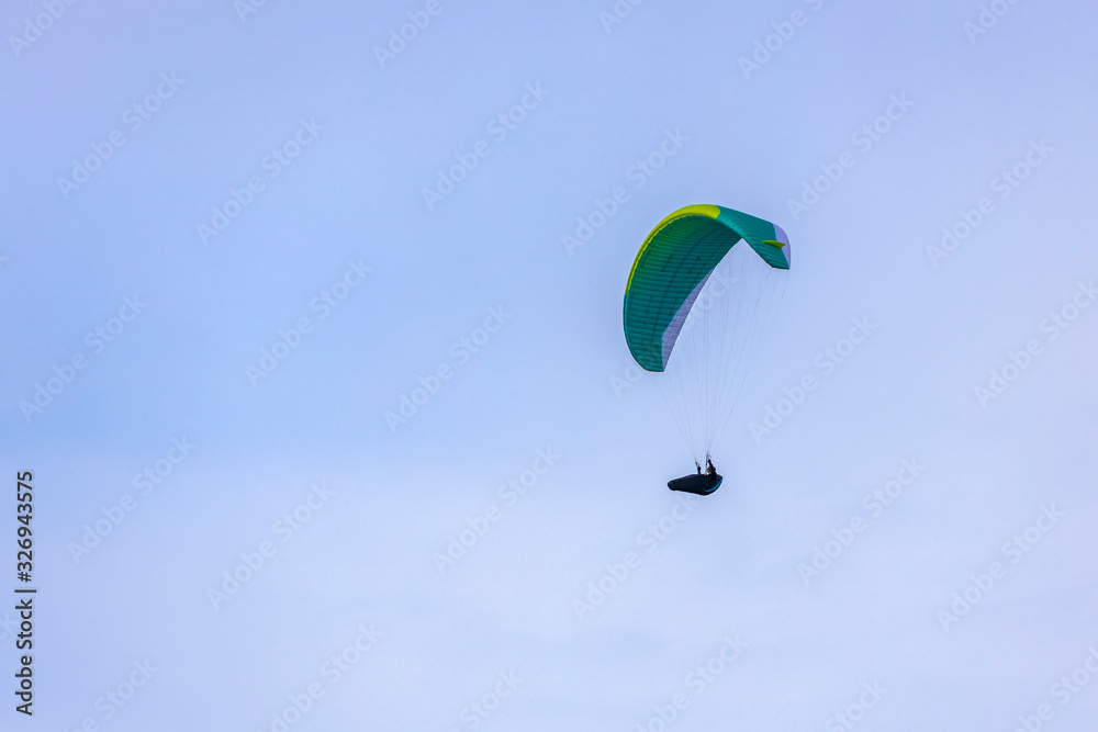 Skydiver On Colorful Parachute In Sky. Active Hobbies Skydiver On Colorful Parachute In Sky. Active Hobbies
