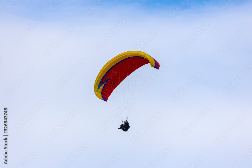Skydiver On Colorful Parachute In Sky. Active Hobbies Skydiver On Colorful Parachute In Sky. Active Hobbies