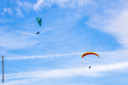 Skydiver On Colorful Parachute In Sky. Active Hobbies