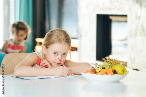 little girl at the table with a notebook