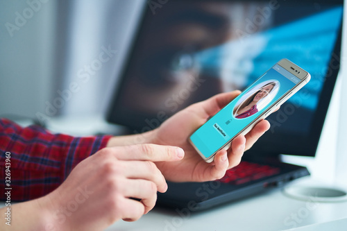 Fotografi Woman unlocking smartphone using facial recognition technology system