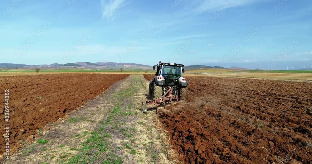 aerial view of the tractor plows in the field, aerial view of the tractor plows in the field,