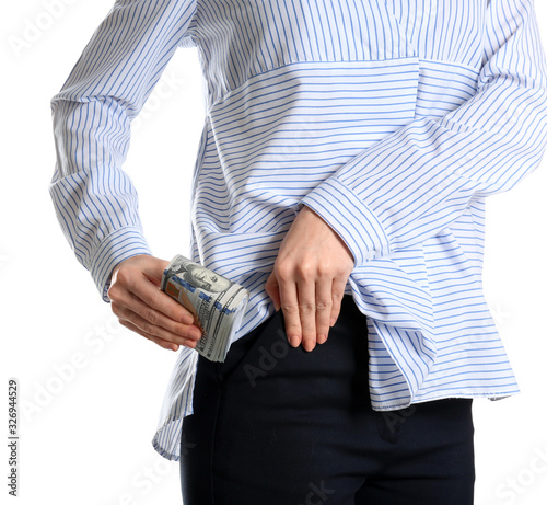 Woman putting bribe into pocket on white background, closeup
