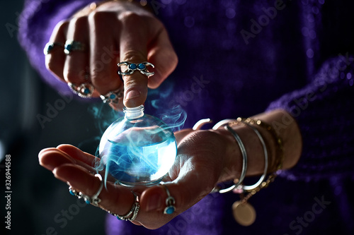 Fantasy witch wizard woman using enchanting magical elixir potion bottle for love spell, witchcraft and divination. Magic illustration and alchemy
