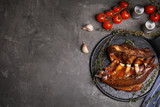 Delicious roasted ribs served on grey table, flat lay. Space for text