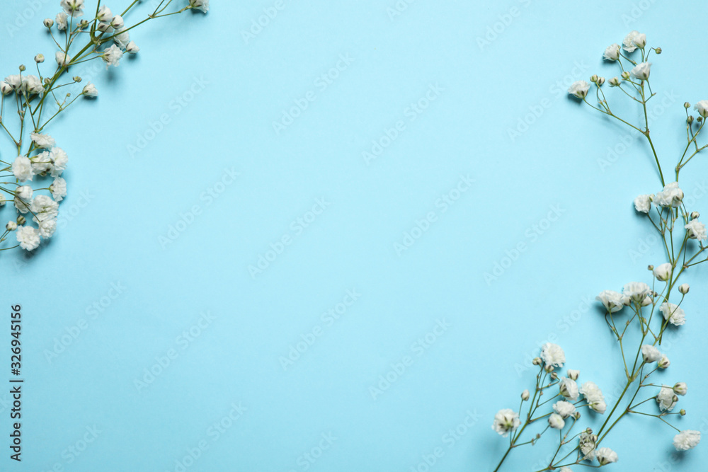 Beautiful floral composition with gypsophila flowers on light blue background, flat lay. Space for text