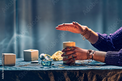 Принти на полотні Gypsy witch woman using candles flame for magic spell during mystical witchcraft