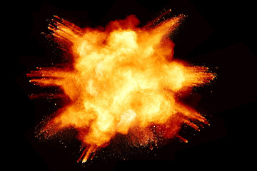 Abstract orange powder explosion isolated on black background.