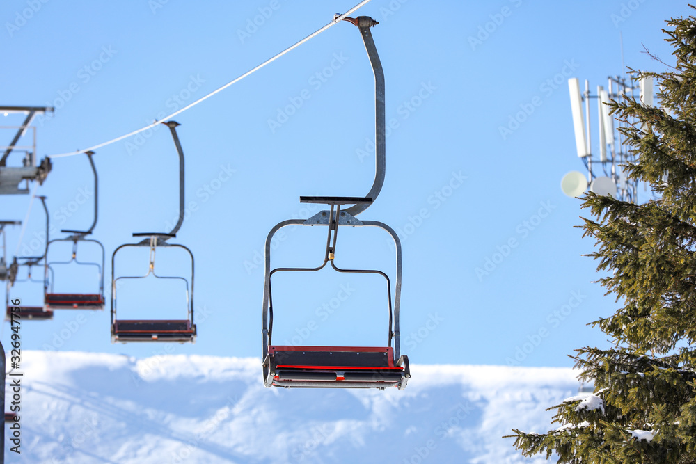 Empty chairlift at mountain ski resort. Winter vacation Empty chairlift at mountain ski resort. Winter vacation