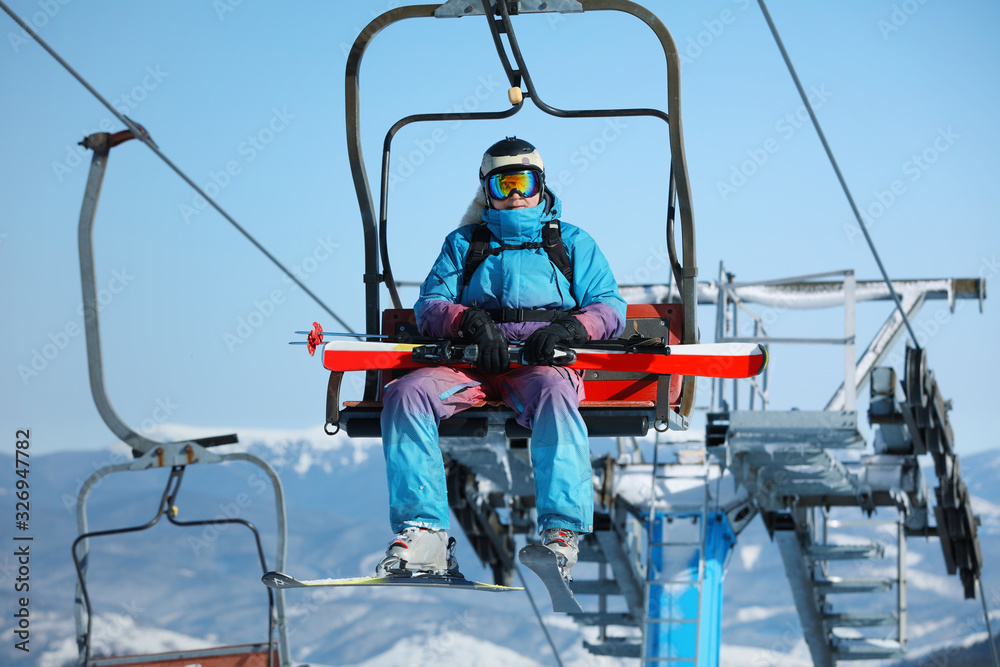 Man using chairlift at mountain ski resort. Winter vacation Man using chairlift at mountain ski resort. Winter vacation