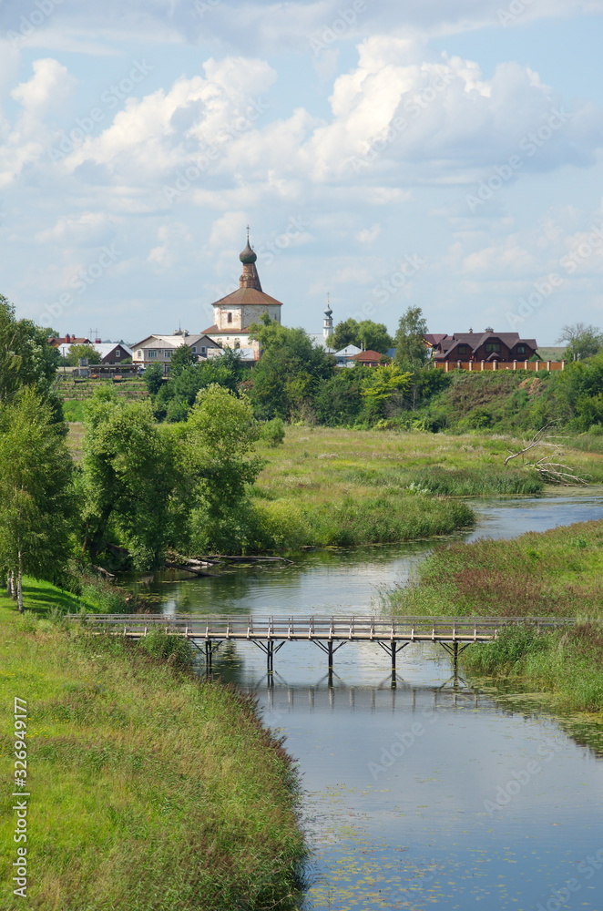 Summer view of the Kamenka river and the Church of Kosma and Damian in Korovniki in Suzdal. Golden ring of Russia