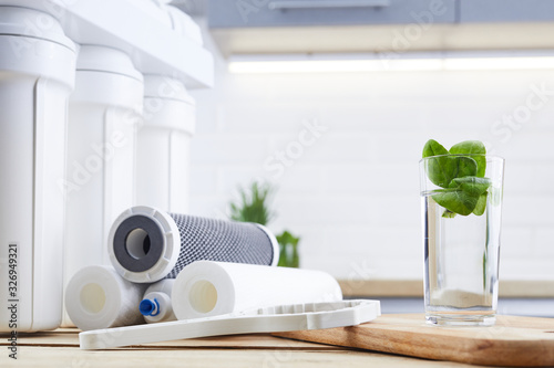 Принти на полотні A glass of clean water with osmosis filter and cartridges a kitchen interior