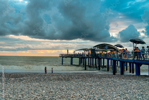 Batumi, Adjara/Georgia - August 05 2019:   Batumi pier is a touristic attraction located in the main pedestrian street of the city, Batumi boulevard. People enjoy Batumi pier. photo