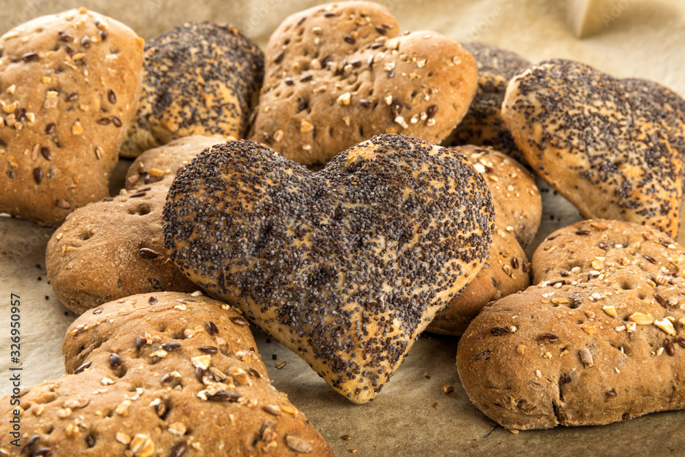 Heart shaped buns with poppy seeds and grains Heart shaped buns with poppy seeds and grains