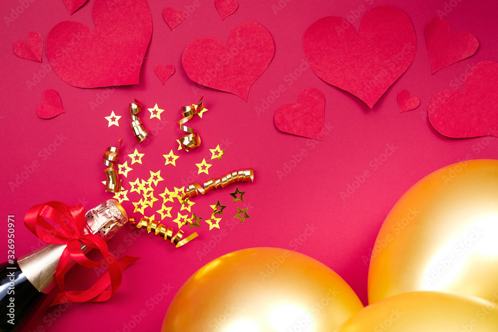 Valentine day background with golden air balloons and paper heart, champagne on pink background. Top view, flat lay.