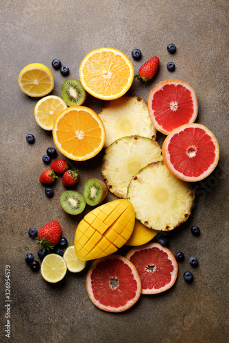 Assorted colorful fruits on the background. Fresh tropical fruits and berries