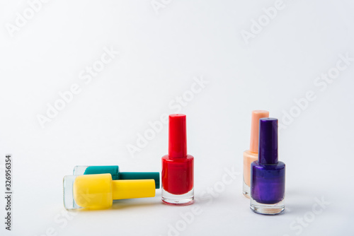 colored nail polishes on a white background