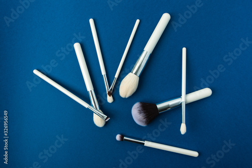 makeup brushes with a white handle on a blue background