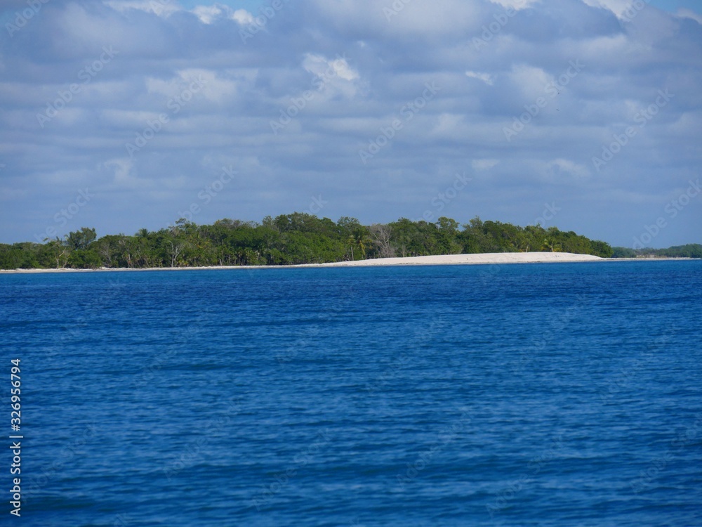 Deep blue waters of the Caribbean sea and a white-sand island in Placencia, Belize. Deep blue waters of the Caribbean sea and a white-sand island in Placencia, Belize.