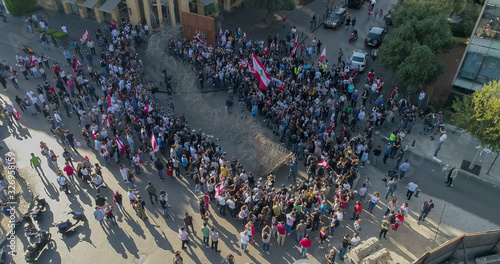 Beirut Lebanon 2019: Aerial drone shot of protesters at Martyrs Square facing the police and wires blocking the road while more protesters join from the other side of the road during the revolution