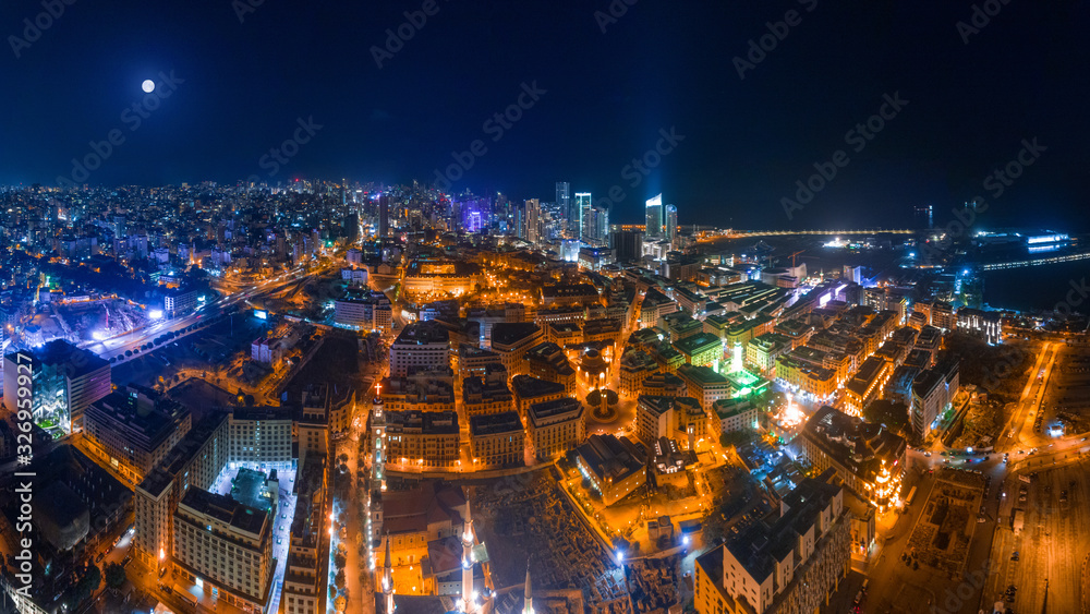Beirut, Lebanon 2019: Panorama aerial drone shot of Downtown Beirut in foreground and city skyline in a full moon night.