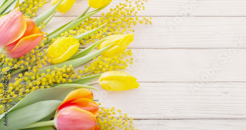 tulips and mimosa on white wooden background #326959954