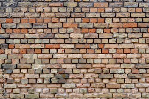 Old stone wall from red brick. Brown color background or wallpaper.