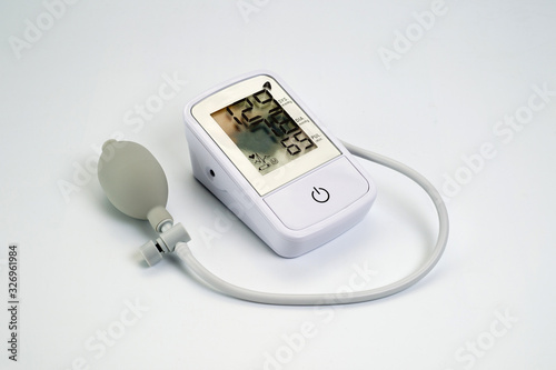 An electronic tonometer, white, for measuring blood pressure. Background for health and medicine.