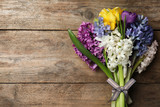Beautiful spring flowers on wooden table, top view. Space for text