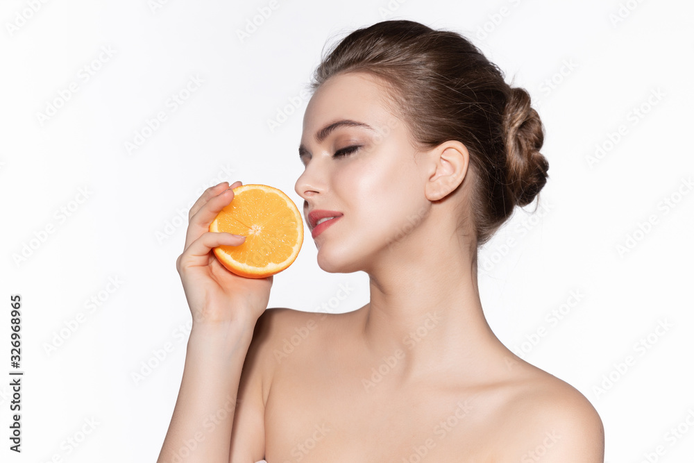 Woman closed her eyes and inhales aroma orange. Mandarin stimulates immune defense, contributes to weight loss and improves mood. Citrus fights against aggressive environmental factors. Woman closed her eyes and inhales aroma orange. Mandarin stimulates immune defense, contributes to weight loss and improves mood. Citrus fights against aggressive environmental factors.