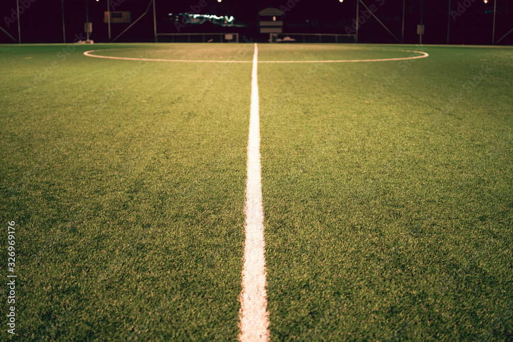 Obraz Widok sztucznej murawy z linii środkowej boiska piłkarskiego fototapeta, plakat