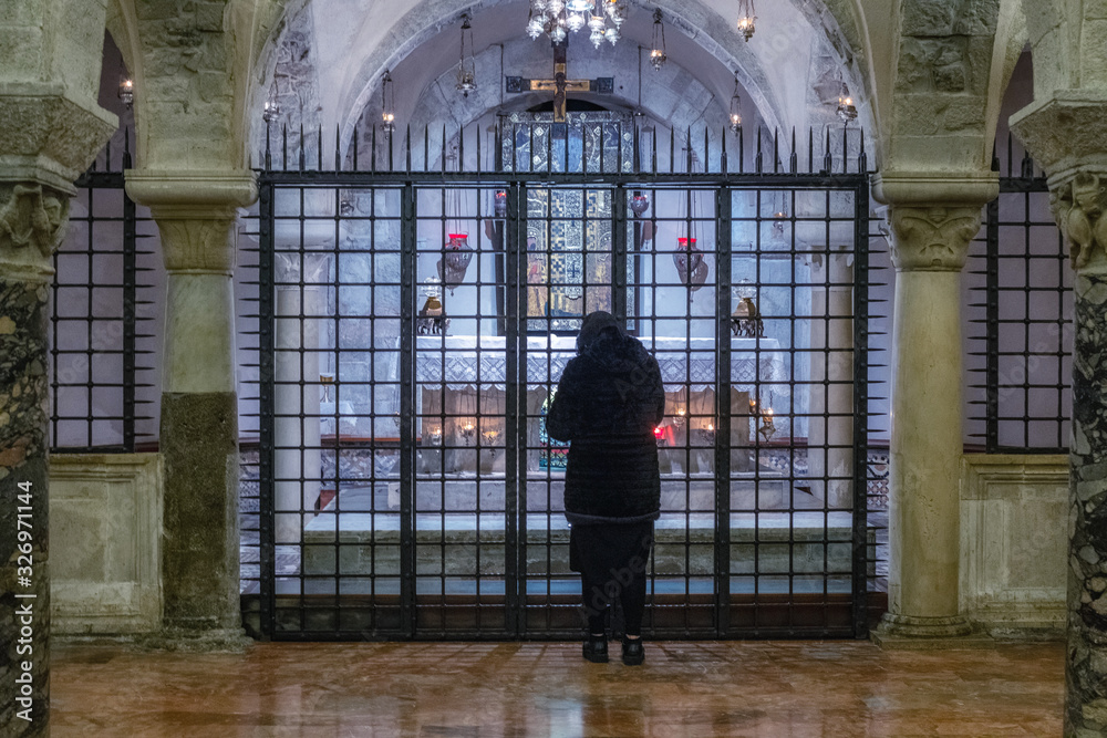 Woman praying in a church Woman praying in a church