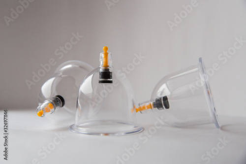 three hijama jars on a white background lie