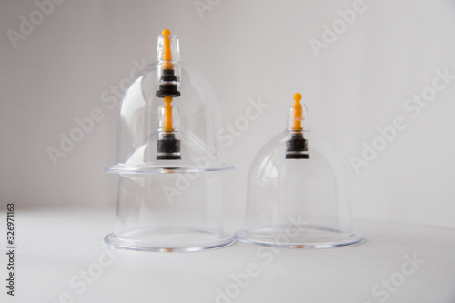 three hijama jars on a white background