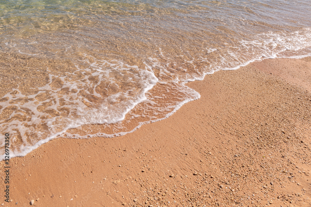 Sea wave on the beach on a sunny day Sea wave on the beach on a sunny day