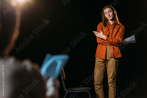 selective focus of handsome actor on casting with theater director