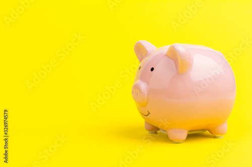 Pink piggy bank on color background. Money saving