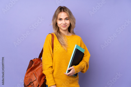 Teenager Russian student girl isolated on purple background laughing