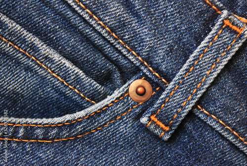 Jeans detail close up, blue denim fabric. Casual jeans front pocket with seams, stitches and metal rivet. Dark blue vintage denim jeans, casual pants element 