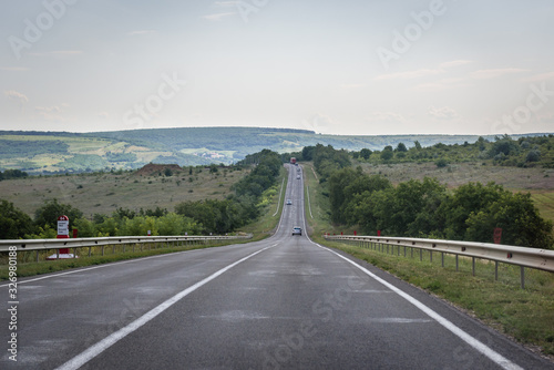 Straight asphalt road through rural area of Moldova photo