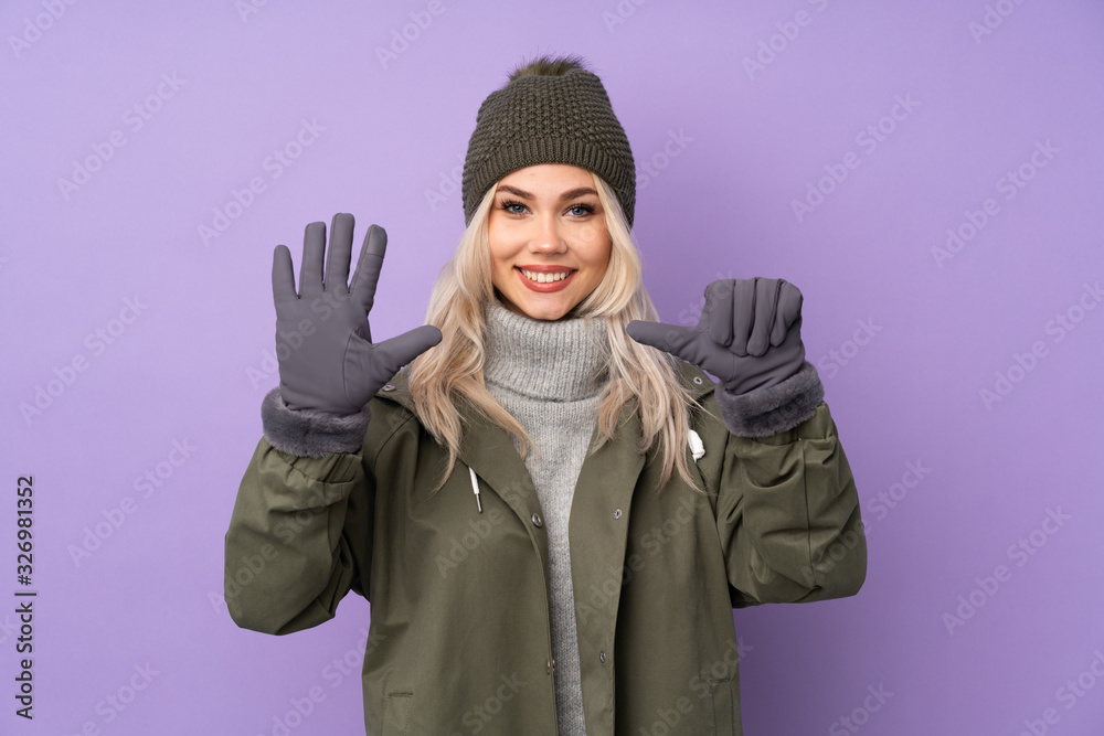 Teenager blonde girl with winter hat over isolated purple background counting six with fingers Teenager blonde girl with winter hat over isolated purple background counting six with fingers