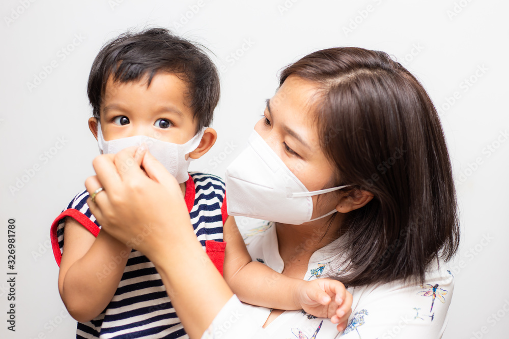 Asian mother carry baby boy wear mask protect pm2.5 and COVID-19 outbreak Asian mother carry baby boy wear mask protect pm2.5 and COVID-19 outbreak